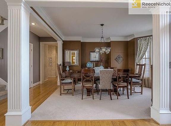 Open floor plan with split staircase, beautiful dining room and gleaming hardwood floors.