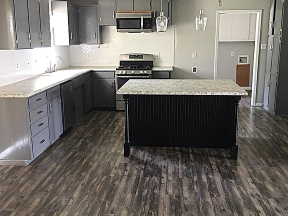 Large kitchen with island and stainless steel appliances