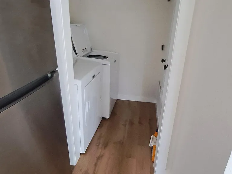 Dedicated laundry nook with in-home washer and dryer, conveniently located off the main living area for easy access.