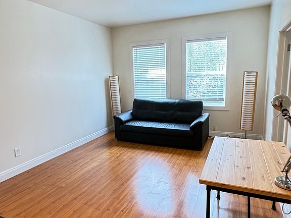 Living room can accommodate a small desk and a lamp as home office.