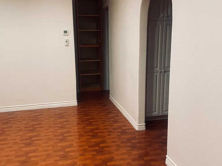Hallway has built in storage cabinet. 1st bedroom to the left of cabinet and 2nd bedroom is to the right