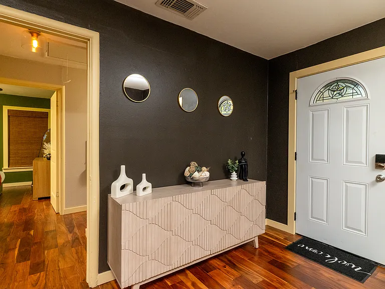 Open and inviting living room featuring a cozy couch, a ceiling fan for comfort, and fun colors that add character and flow.