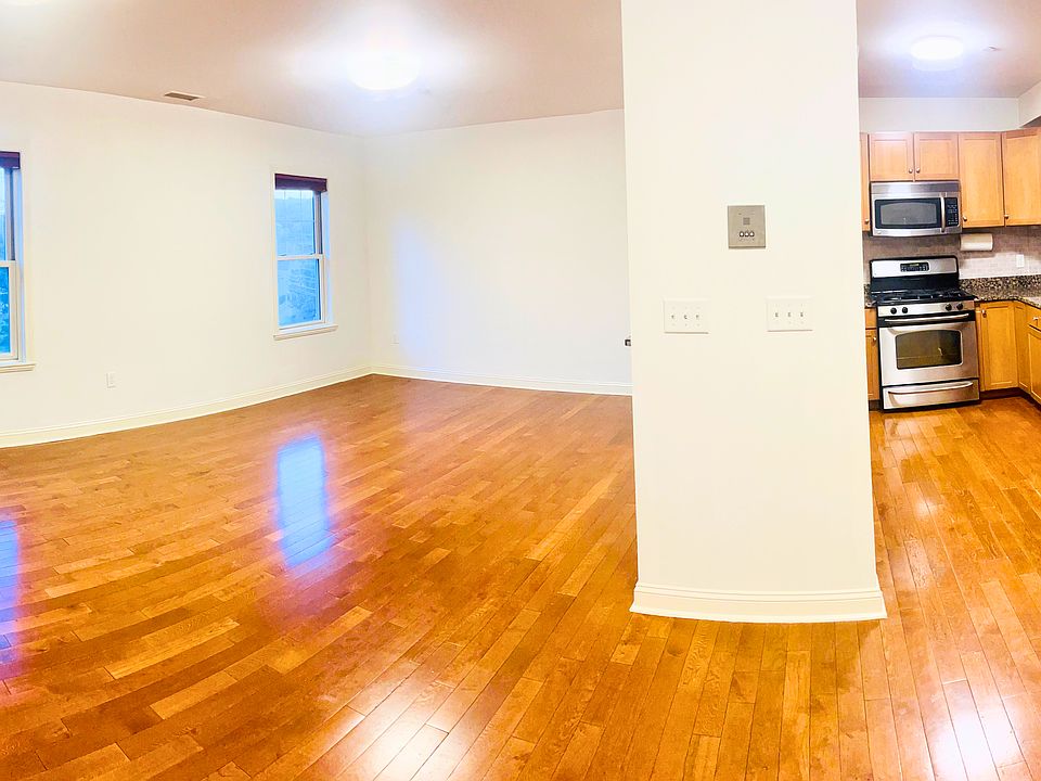 3D view of the living dining area, with kitchen and half bath all on the first level