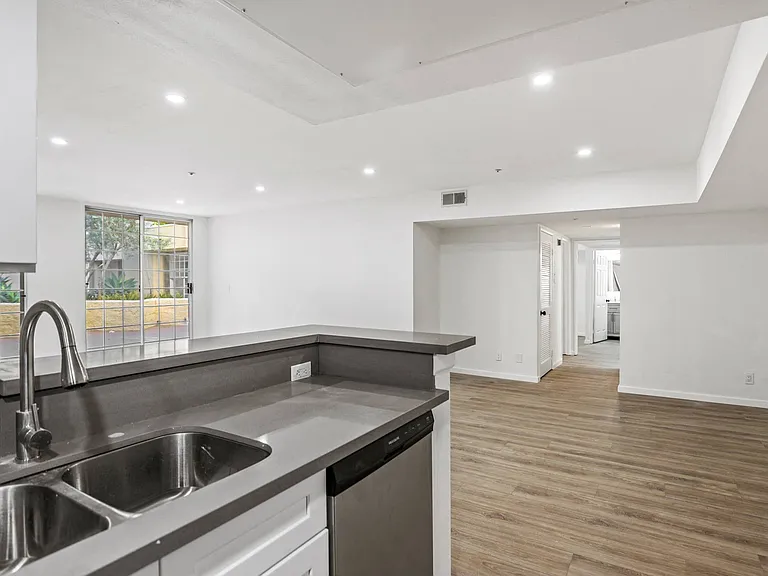 Open-Concept Kitchen and Dining Area with Recessed Lighting and Vinyl Flooring