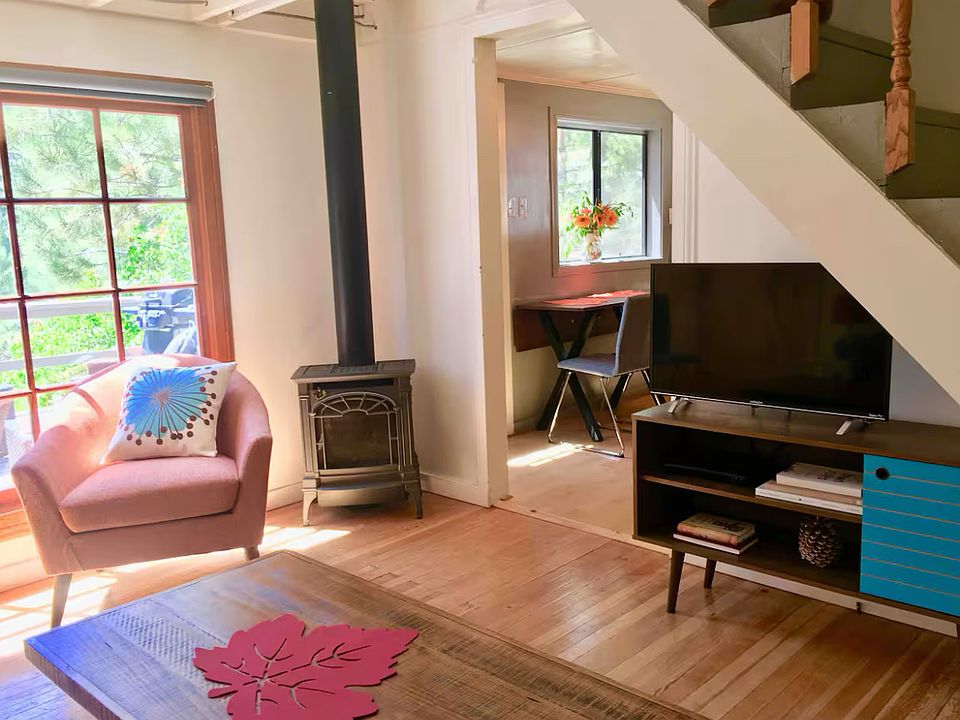 Living room with Lopi gas stove fireplace, looking towards kitchen