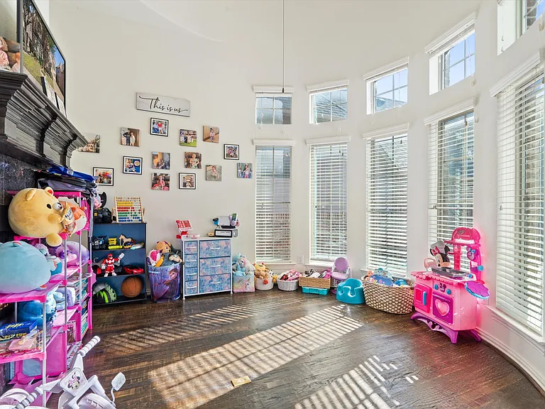 You'll find an extra living room on the second floor featuring a charming decorative fireplace_one of four lovely fireplaces throughout the home!