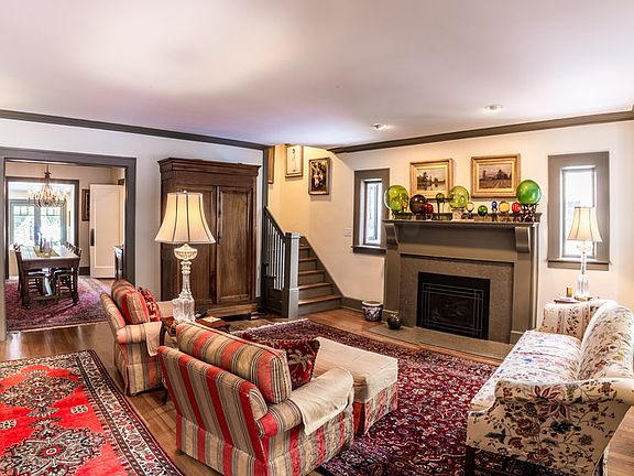 Comfortable living room sports custom built-ins, crown molding, and high end Mendota gas fireplace with custom mantle. The hardwood flooring has been refinished throughout!