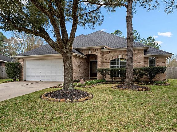 Another amazing view of the front yard shows mature trees that provide the perfect amount of shade! The beautiful neutral brick exterior is a combination of differing tones creating dimension.