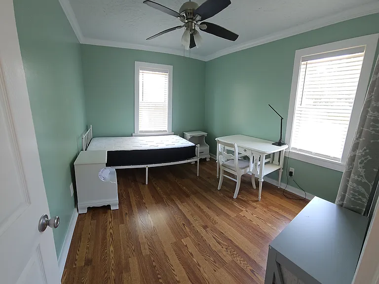 2nd bedroom with twin size bed, nightstand, desk and portable dresser.