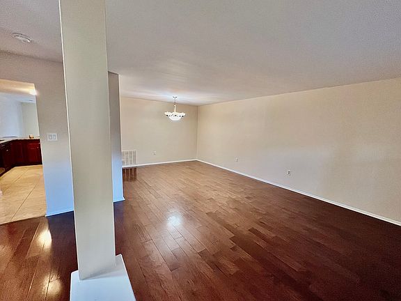 Open concept formal living and dining room, featuring newly installed hardwood floors