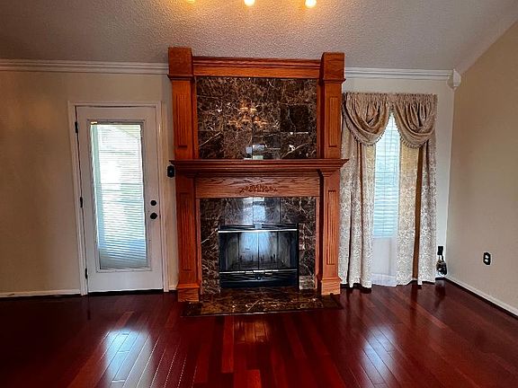 Living Room - Featuring a marble surround fireplace with overhead lighting.