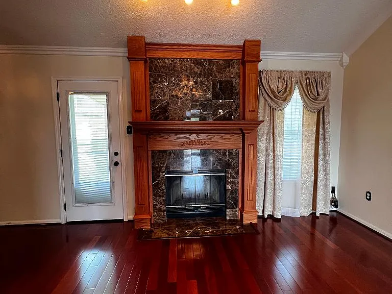 Living Room - Featuring a marble surround fireplace with overhead lighting.