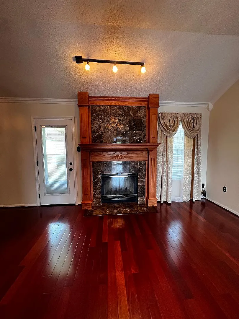 Living Room - Featuring a marble surround fireplace with overhead lighting. - 918 Whirlaway Dr