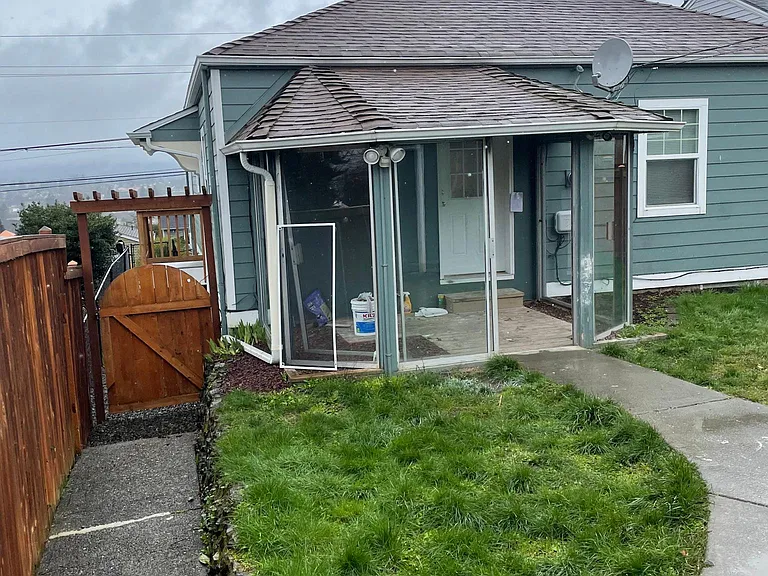 Back of house from side of garage. This is the back entrance to home and it accesses a bedroom.