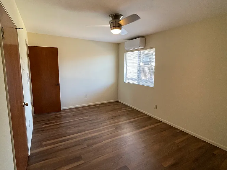 Roomy, bright bedroom with quiet mini split a/c and heat, ceiling fan, and clothing closet.