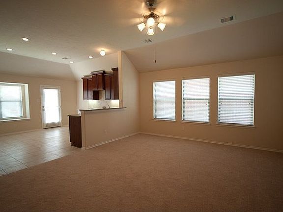 Light and bright family room with recessed lights and breakfast bar.