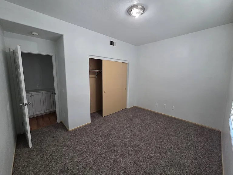 Spacious downstairs bedroom conveniently located near a full bathroom.