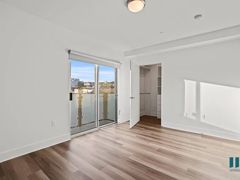 Bedroom with Patio, Walk-In Closet, and Vinyl Flooring