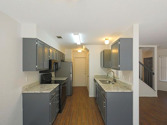 Kitchen with new fridge, stove, microwave, dishwasher, and granite countertops.