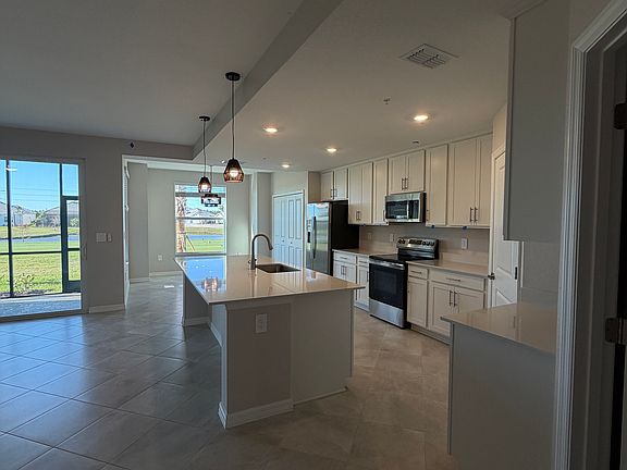 Open-concept living, dining, and gourmet kitchen with sweeping golf course views.