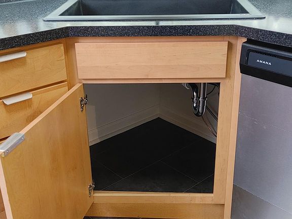 Plenty of clean space under the new sink and faucet.