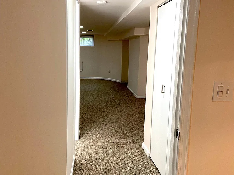 View of the hallway from bedroom looking into the living room