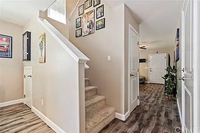 Living area flow to kitchen and stairs to bedrooms