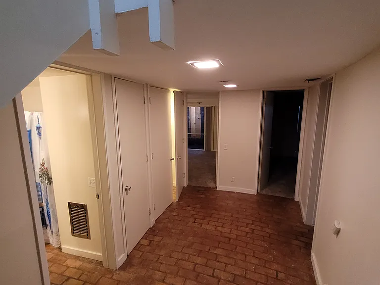 Downstairs foyer facing lower-level rooms and laundry room
