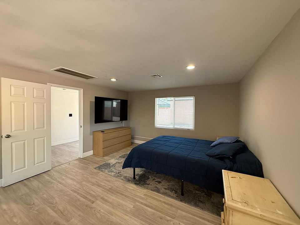 Comfortable furnished sleeping area with 65-inch mounted TV, high-speed fiber Wi-Fi, dresser and comfortable queen bed.