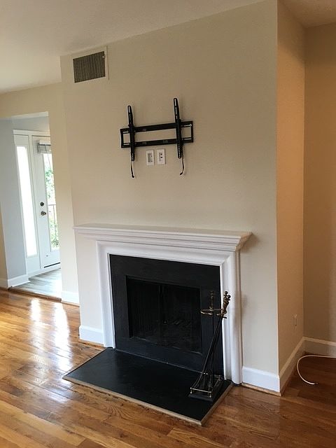 Fire place in living room with hardwood floores