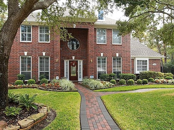 Paved brick sidewalk and large shade trees