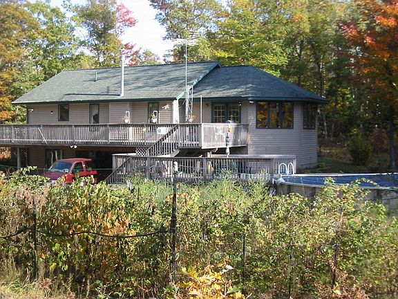view showing great room, pool area and fenced garden area.