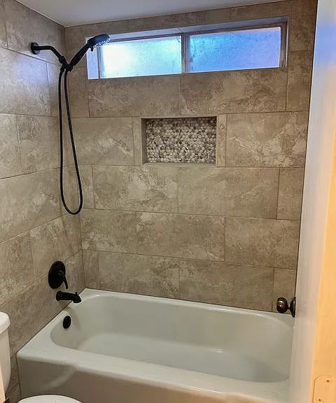 2nd bath features all-new tiled tub surround and fixtures.
