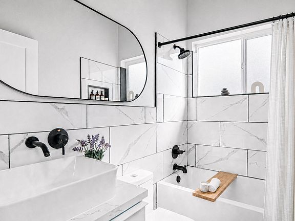 Bathroom features European fixtures, vessel sink, floating vanity