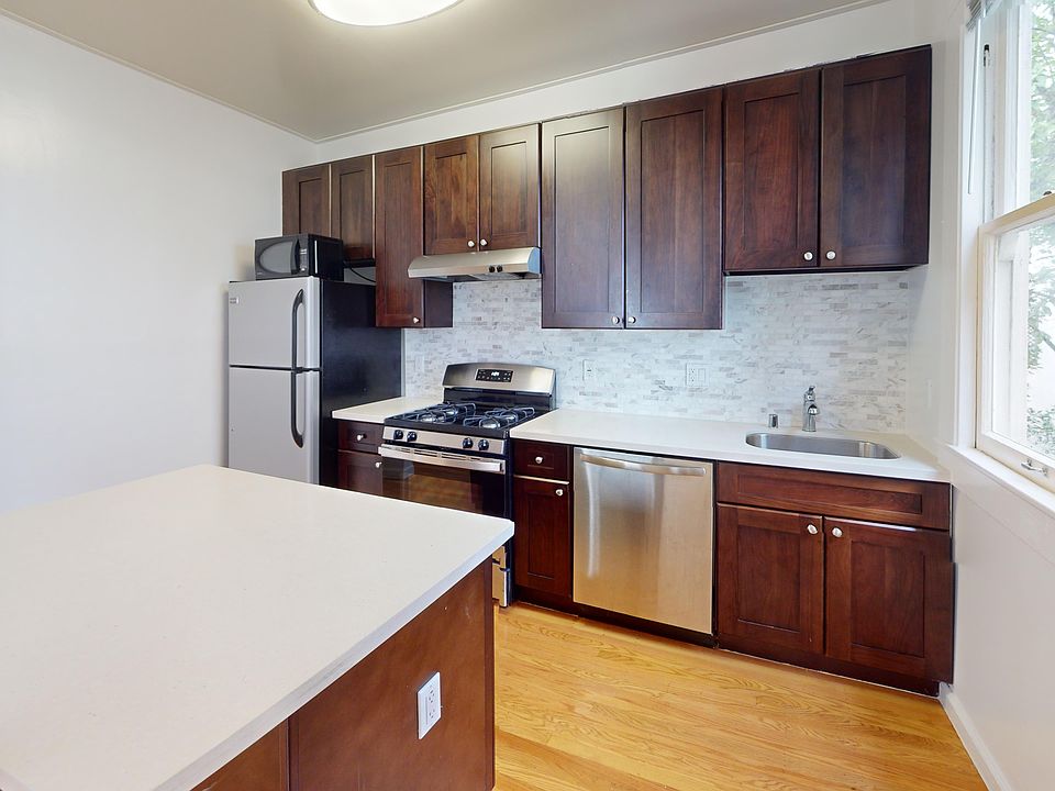 Kitchen with cabinets, countertop, stainless appliances, and natural light