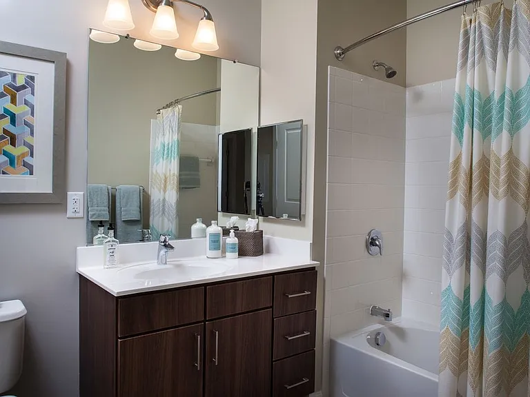 Classic Bath with chocolate pecan cabinetry, white laminate countertops, and hard surface flooring