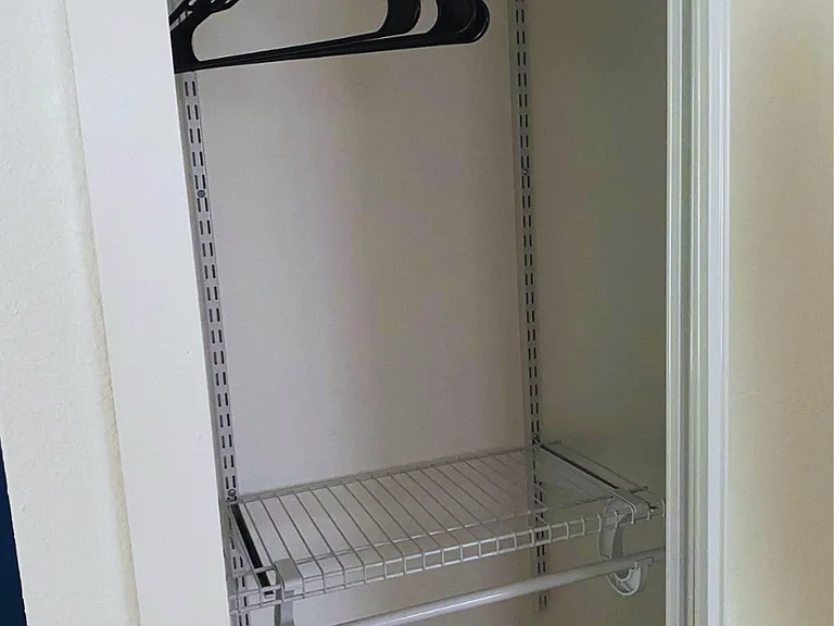 Spacious closet with hangers and plenty of storage space.
