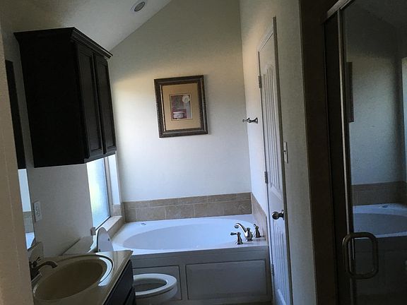 Master bathroom with 2 sinks,bathtub,shower,and walk in closet.