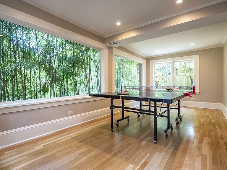 Ping-pong table in daylight basement.