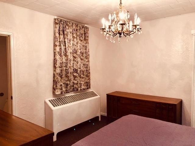 Another view of the front bedroom. Entry to the attached half bath is on the left.