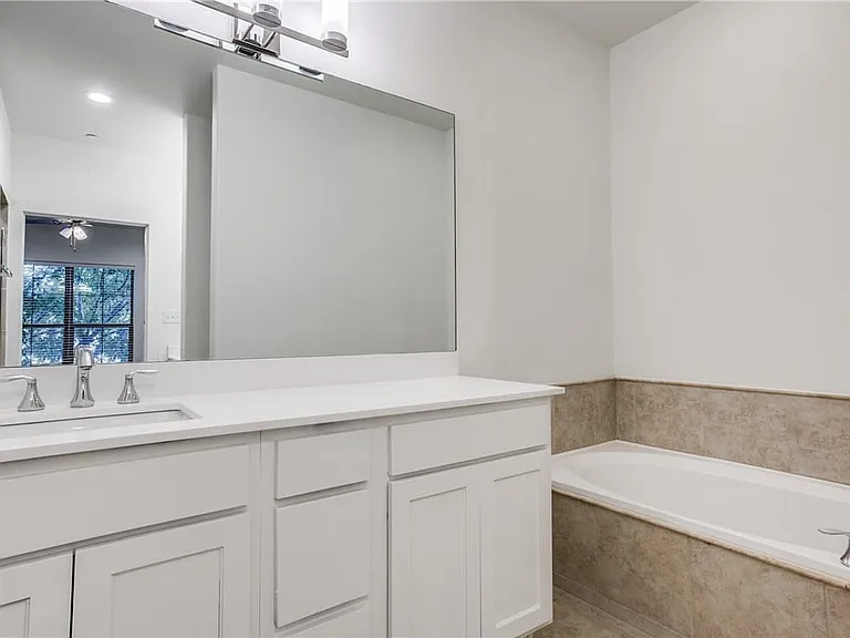 Updated fixtures and large soaking tub complete the master bath
