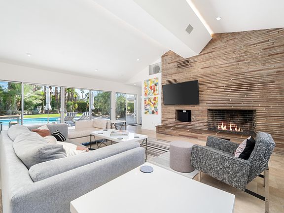Living room view of fireplace and pool.