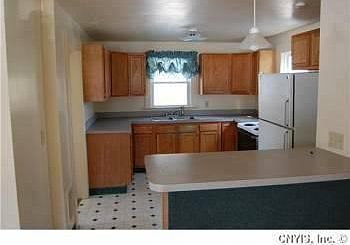 Walking in the front door, looking into the open kitchen