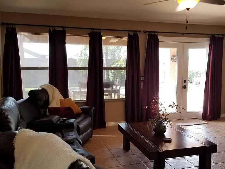 Close all curtains to darken room to simulate home theater