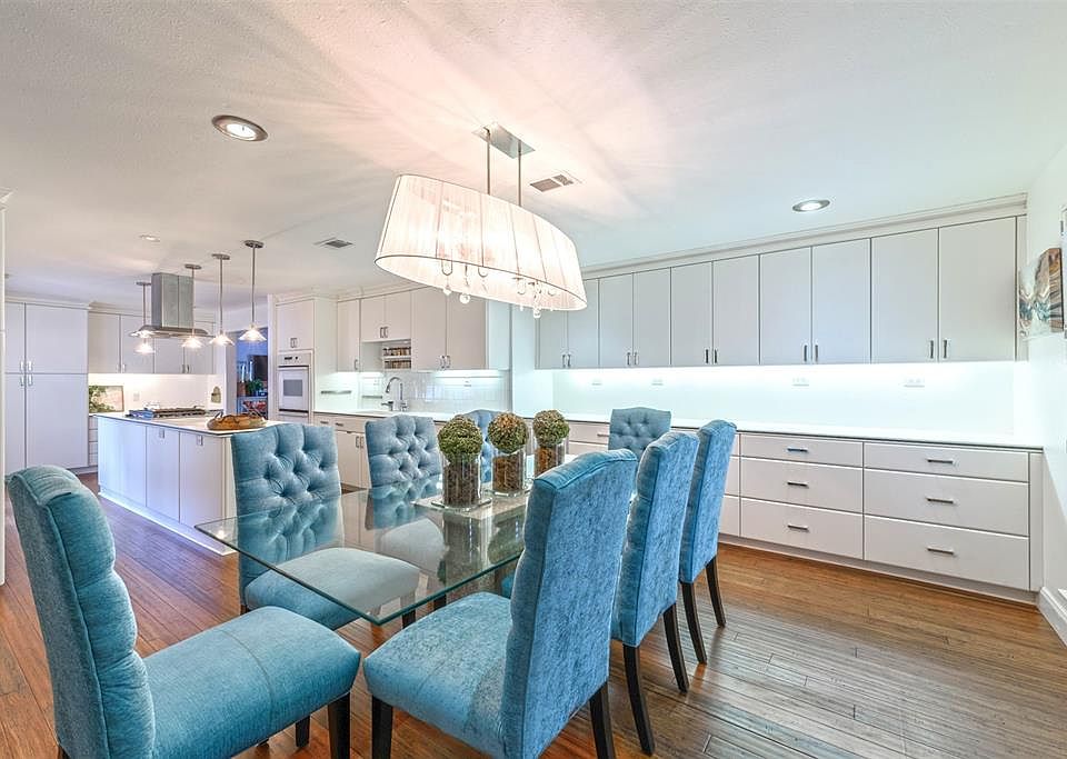 Welcome to your mid-century remodeled retreat in the historic, highly sought after neighborhood of Oak Forest.These sleek white cabinets, walls, backsplash and countertops add a clean modern note to this very chic dining/cooking experience.