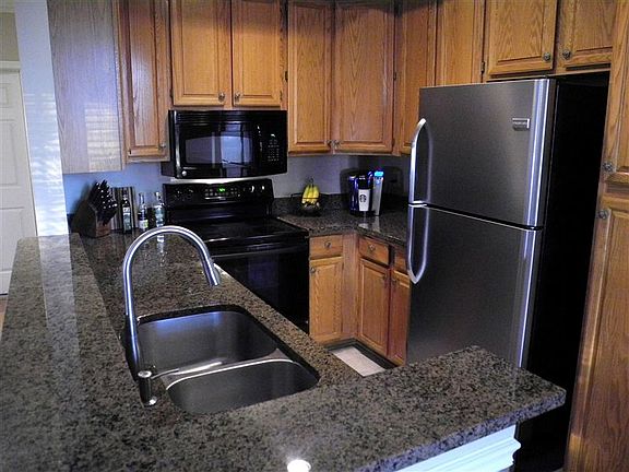 Stainless steel refrigerator, and dishwasher. Granite counte