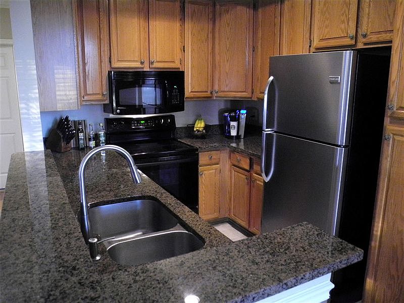 Stainless steel refrigerator, and dishwasher. Granite counte