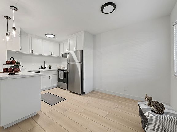 Adjoining open dining area is filled with natural light from the large window _ the perfect space for everyday living and entertaining.