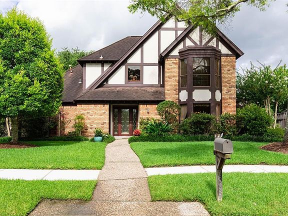 The front of the home has excellent curb appeal with extensive landscaping.