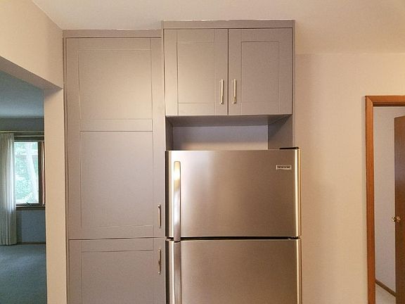 Kitchen pantry. New stainless steel appliances.